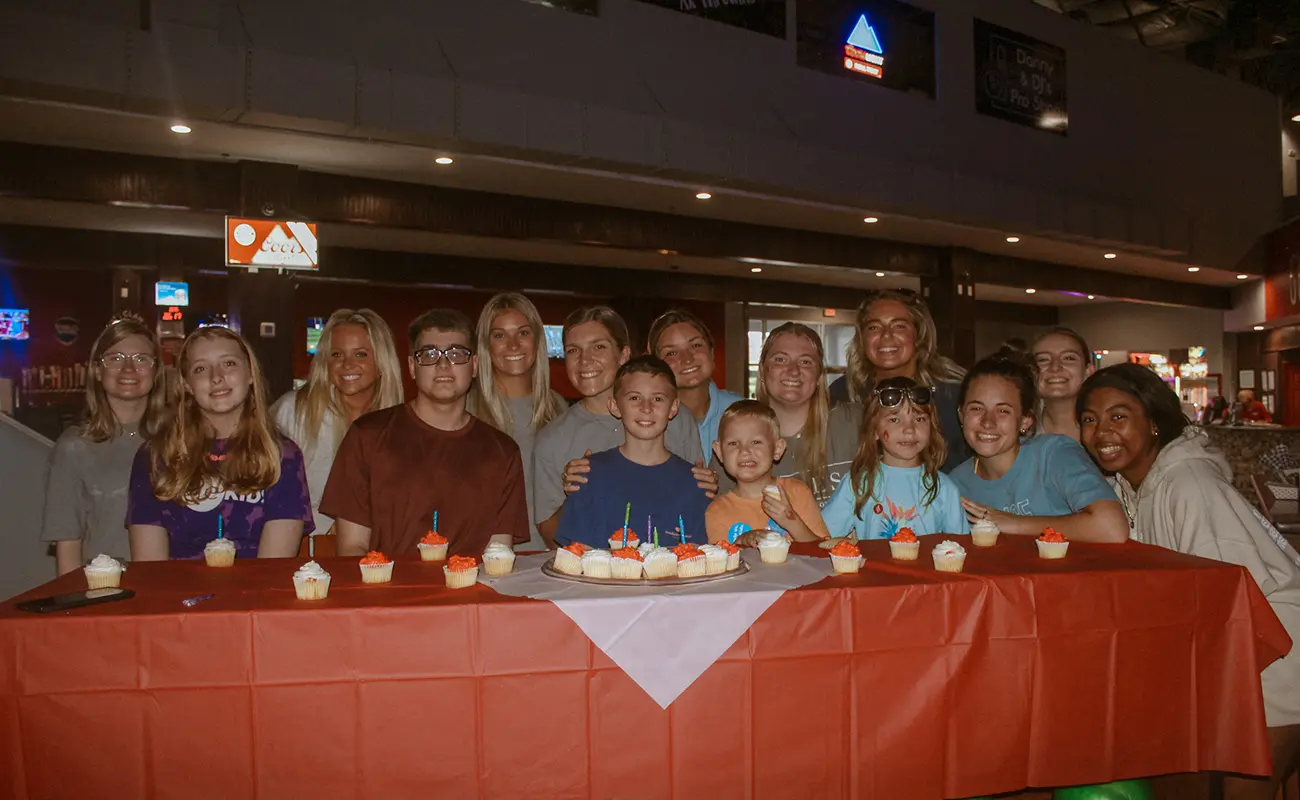 UA Miracle family at table with cupcakes